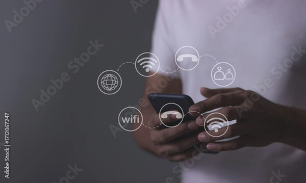 Fototapeta Young man hand using smartphone with to Interconnect, Interconnected Concept; People connect via wireless internet in a world of digital technology and communications that connect