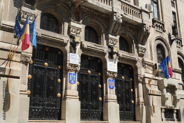 Fototapeta Bucharest, Romania – August 10, 2025: Facade of historic building, built between 1914-1926 in neo-romanian architectural style, nowadays headquarters of The General Inspectorate of the Romanian Police