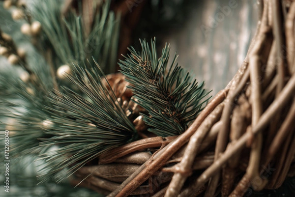 Fototapeta Handmade wicker wreath embracing natural pine details in close-up view