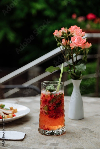 Obraz Refreshing cocktail with flowers on a table