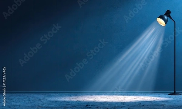 Obraz Dramatic spotlight illuminates a dark blue room, creating a captivating atmosphere.