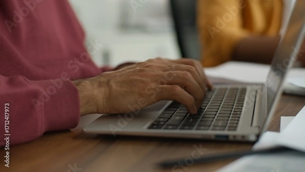 Fototapeta Close up unrecognizable business man typing laptop working computer process creative modern coworking unrecognizable informal team meeting startup partners international people briefing brainstorming