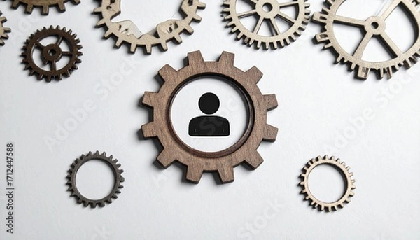 Fototapeta Human Resources in the Cogwheel: A conceptual shot features a prominent cogwheel with a central human silhouette, signifying human resources and workforce management.
