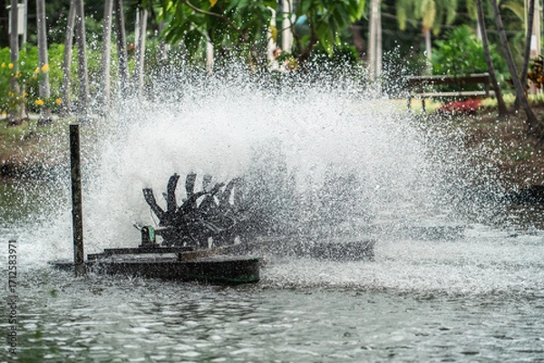 Fototapeta rotating water oxygen generator in park creating droplets, eco-friendly aeration device in pond producing dynamic water splashes, Lumpini park, Bangkok