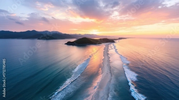 Fototapeta Sunsets over the calm sea reveal a beautiful coastline with gentle waves and scenic islands in the distance