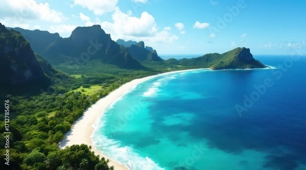 Fototapeta Scenic view of a tropical beach and lush mountains under a bright blue sky on a sunny day