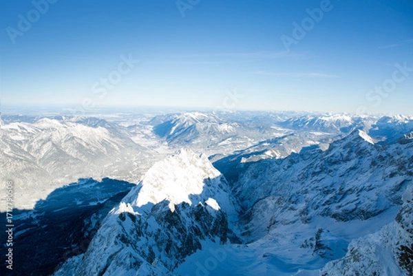 Fototapeta Panoramic view of beautiful winter mountain scenery in the Alps in sun light.