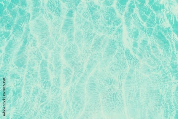 Fototapeta The texture of the shallow water surface, with characteristic reflections and distortions created by ripples, creates a feeling of calm and freshness.