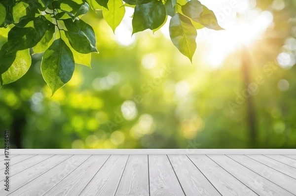 Fototapeta Blurred natural green foliage with bokeh effect and white wooden floor in the foreground, set against a spring-autumn park backdrop. Soft light and leaf rays create an abstract forest landscape.
