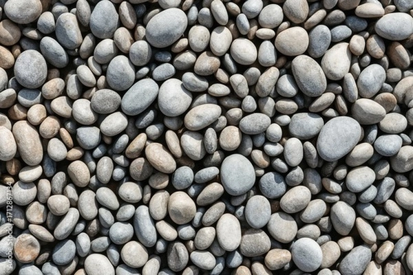 Fototapeta Close-up of smooth, rounded stones surface. Detailed pebbles texture. High-resolution image.