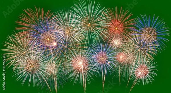 Fototapeta Vibrant fireworks explode in a dazzling display of color across a deep green night sky