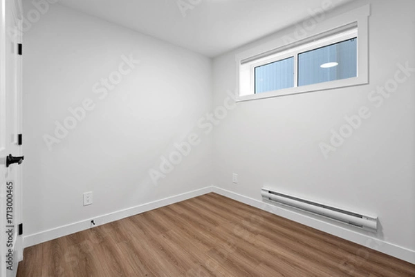 Fototapeta Small, empty room with a window and a radiator