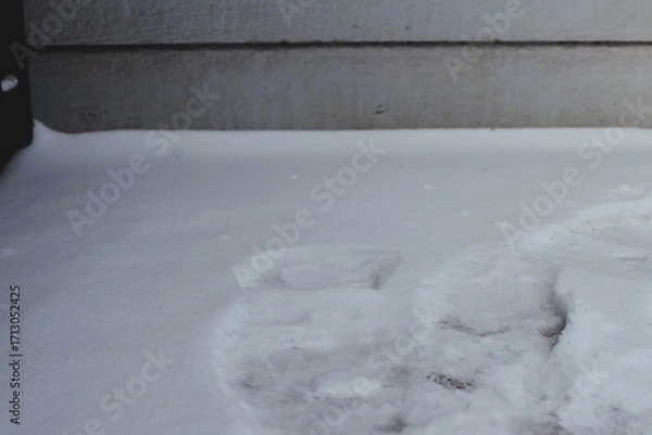 Obraz Melted Footprints in Snow by Exterior Wall