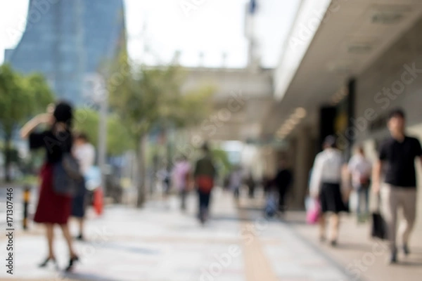 Fototapeta People Walking in the Middle of the City During Day at the City of Nagoya in Japan; Blur Background with Bokeh Effects