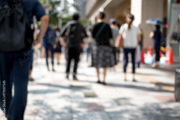 Fototapeta People Walking in the Middle of the City During Day at the City of Nagoya in Japan; Blur Background with Bokeh Effects