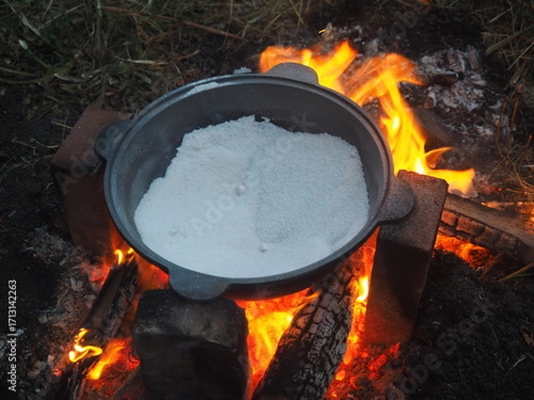 Fototapeta fire in a fireplace The first firing of the cauldron over an open fire with table salt