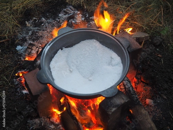 Fototapeta fire in a fireplace The first firing of the cauldron over an open fire with table salt