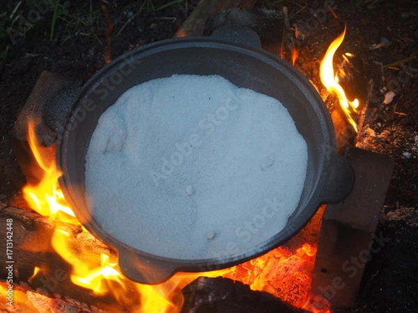 Fototapeta fire in a fireplace The first firing of the cauldron over an open fire with table salt