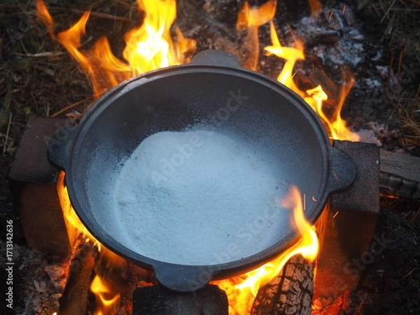 Fototapeta fire in a fireplace The first firing of the cauldron over an open fire with table salt