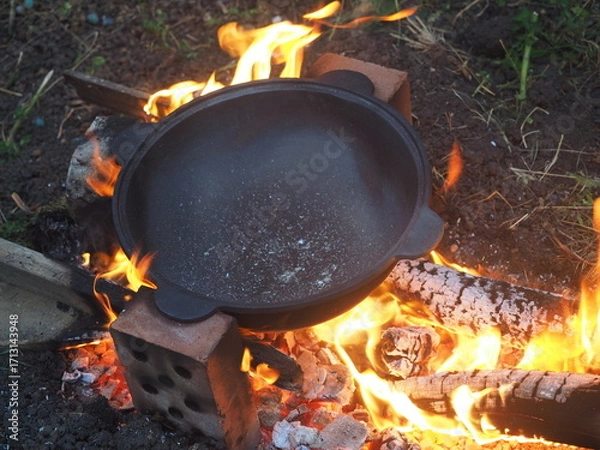 Fototapeta campfire in the forest The first firing of the cauldron on an open fire