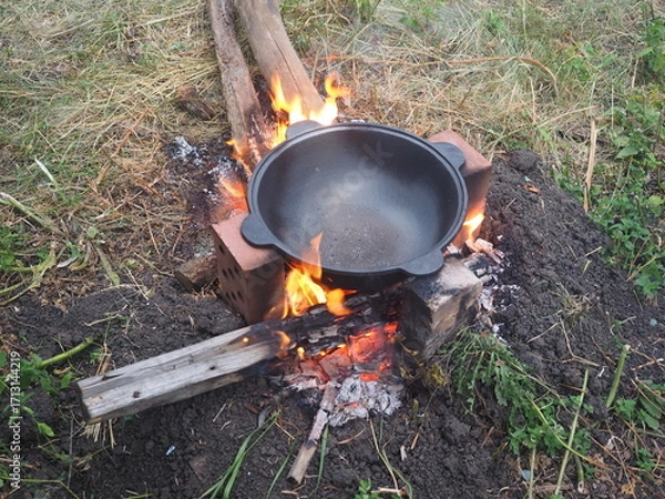 Fototapeta kettle on fire The first firing of the cauldron on an open fire