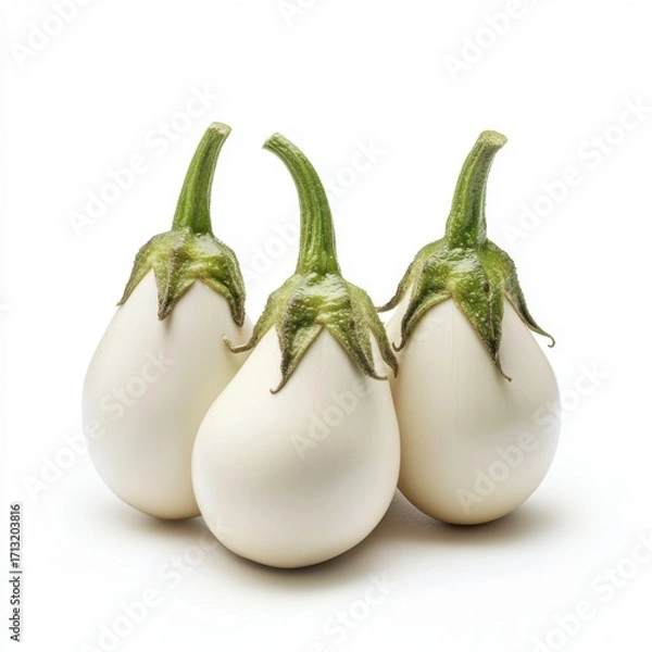 Fototapeta Three white eggplants arranged artistically on a clean background, showcasing their unique shape and texture.