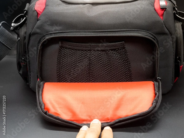 Fototapeta Generic black and red camera bag with shoulder strap, camera bag concept