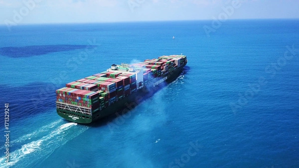 Obraz Mega huge fully loaded container ship at sea aerial top down