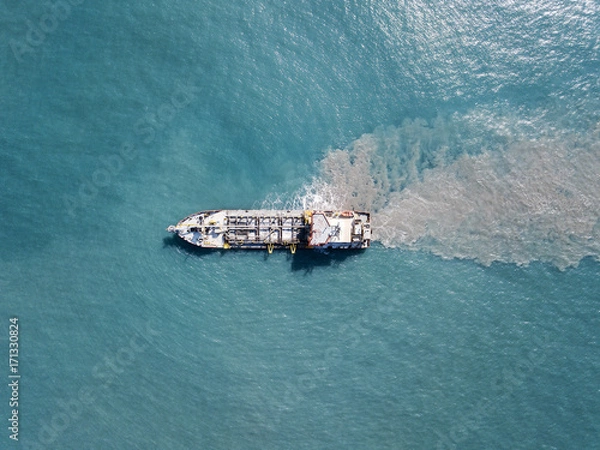Obraz Suction Dredger ship working near the port - with mud, Pollution, brown Muddy water - aerial tip down shot