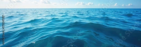 Fototapeta Vast expanse of deep blue ocean water, sunlit surface with gentle waves, tranquil scene of marine environment Perfect for travel, nature, or environmental themes , ocean water, travel