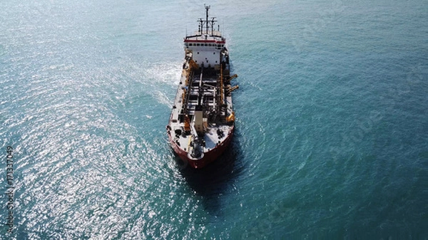 Obraz Suction Dredger ship working near the port - with mud, Pollution, brown Muddy water - aerial shot