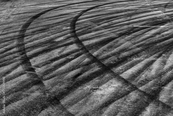 Fototapeta Black tire marks on road, Black rubber tire marks and tread marks, Tire trace track wheels texture and background, Auto tire tread grunge, Car wheel tyre tread track black tyre print.