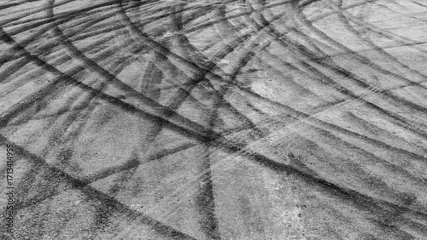 Fototapeta Black tire marks on road, Black rubber tire marks and tread marks, Tire trace track wheels texture and background, Auto tire tread grunge, Car wheel tyre tread track black tyre print.