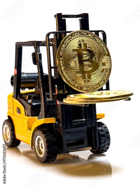 Fototapeta A yellow loader lifts a large gold bitcoin.