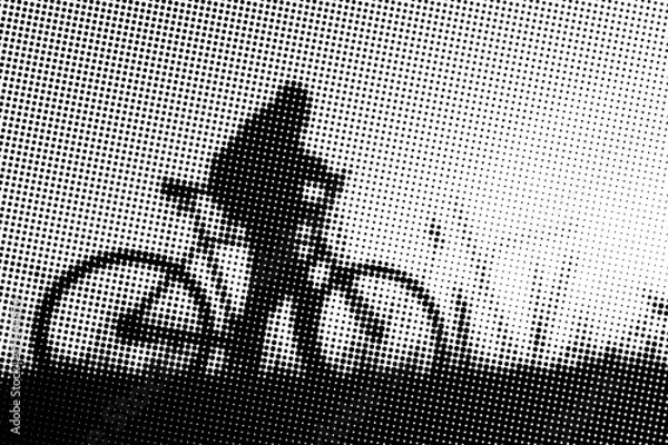 Fototapeta Man with bicycle at sunset - monochrome halftone pattern background