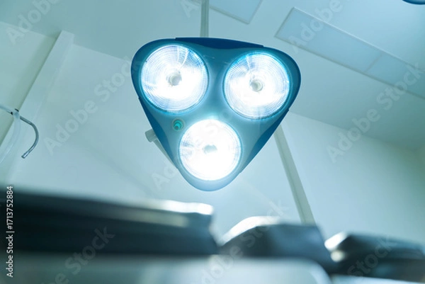 Fototapeta Operating room lights. Illuminated by operating lights in the background.