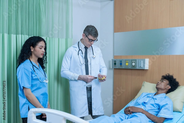 Fototapeta The doctor is explaining the treatment to the patient. A man lying sick in hospital.