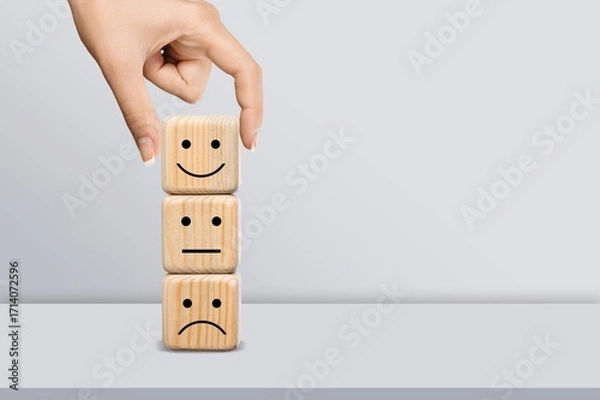 Fototapeta Hand choosing wooden block with face image