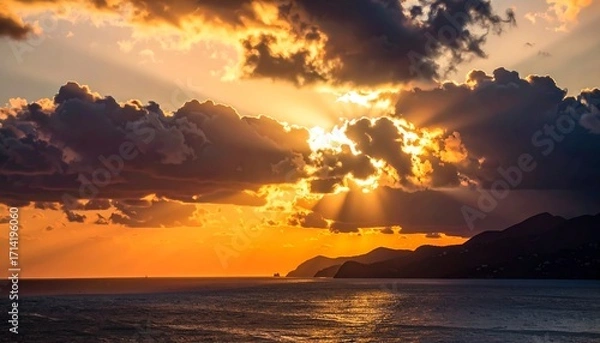 Fototapeta Dramatic sunset over the ocean with dramatic clouds