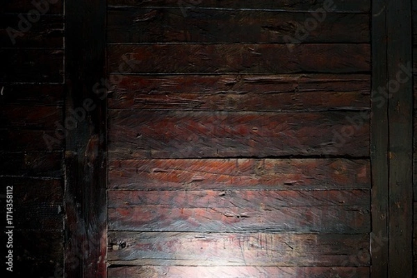 Fototapeta Close-up texture of old dark wooden beams illuminated from below, with visible scratches and natural grain creating a rustic background.