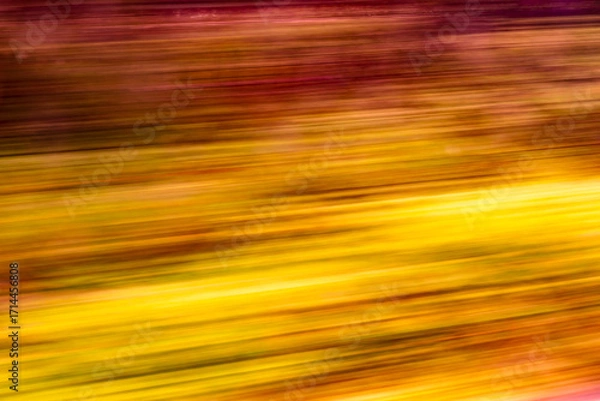 Fototapeta Dynamic motion blur view from high-speed train window: Green landscape, trees & fields rush past at high speed