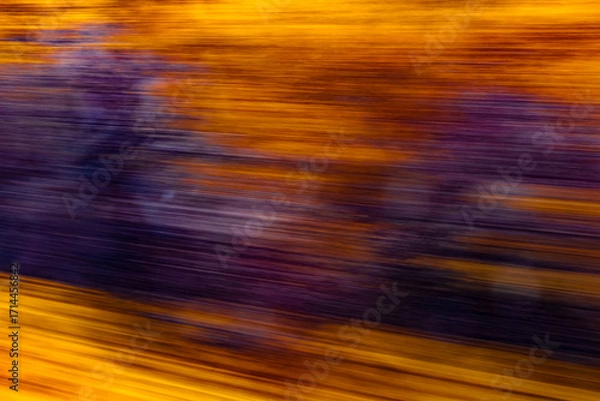 Fototapeta Dynamic motion blur view from high-speed train window: Green landscape, trees & fields rush past at high speed