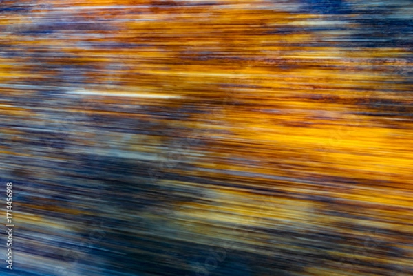 Fototapeta Dynamic motion blur view from high-speed train window: Green landscape, trees & fields rush past at high speed