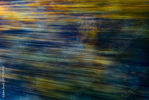 Fototapeta Dynamic motion blur view from high-speed train window: Green landscape, trees & fields rush past at high speed