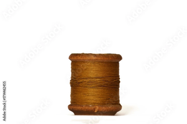 Fototapeta Old wooden bobbin of thread isolated on white