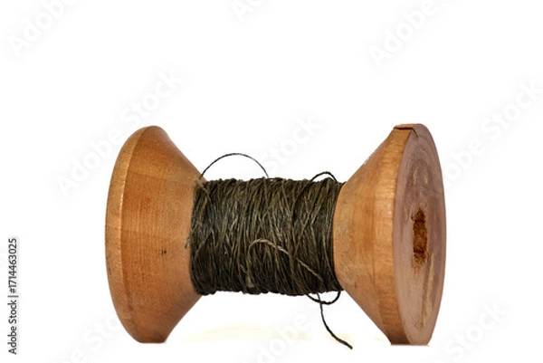 Fototapeta Old wooden bobbin of thread isolated on white
