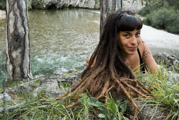 Obraz Beautiful hippie girl at an alpine river in Austria