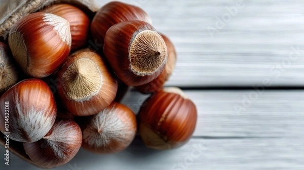 Fototapeta Hazelnut Harvest: A close-up still life captures the natural beauty of freshly harvested hazelnuts, showcasing their rich texture and inviting appearance.