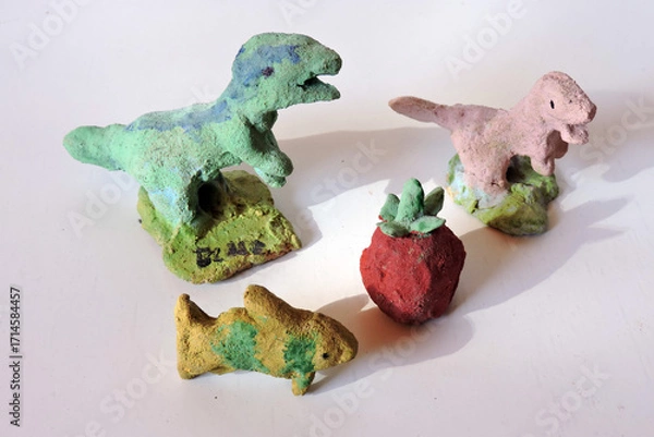 Fototapeta A set of colourful painted clay figurines carved by a child