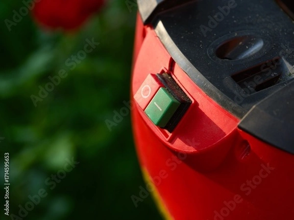 Fototapeta Close-up shot of On and Off buttons on a red garden machine control panel.